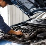 Turbo petrol engine being inspected by mechanic in Indian car workshop after three years of ownership
