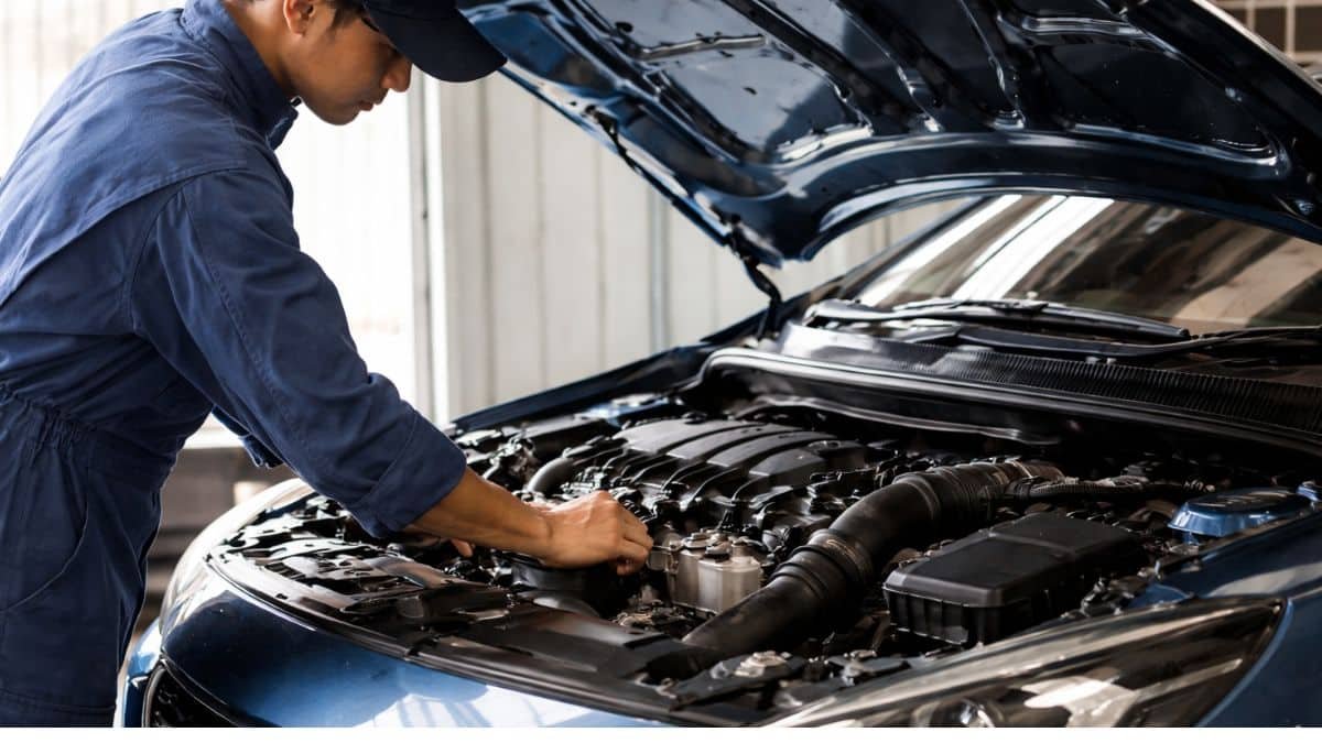 Turbo petrol engine being inspected by mechanic in Indian car workshop after three years of ownership