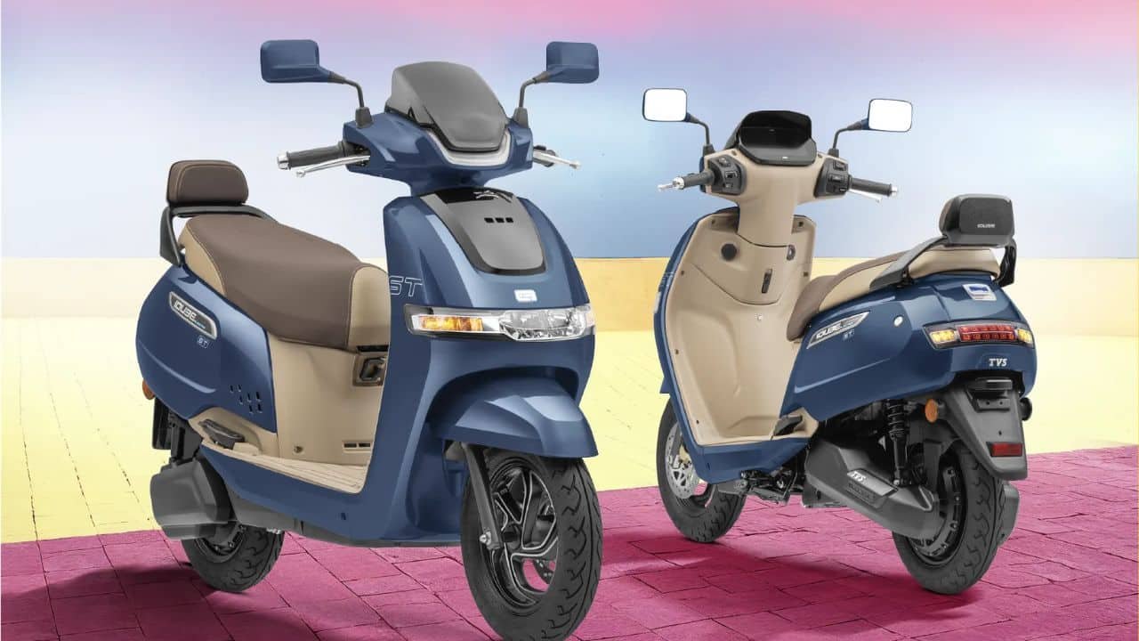 TVS iQube ST electric scooter parked in urban setting showing TFT display and premium dual tone design