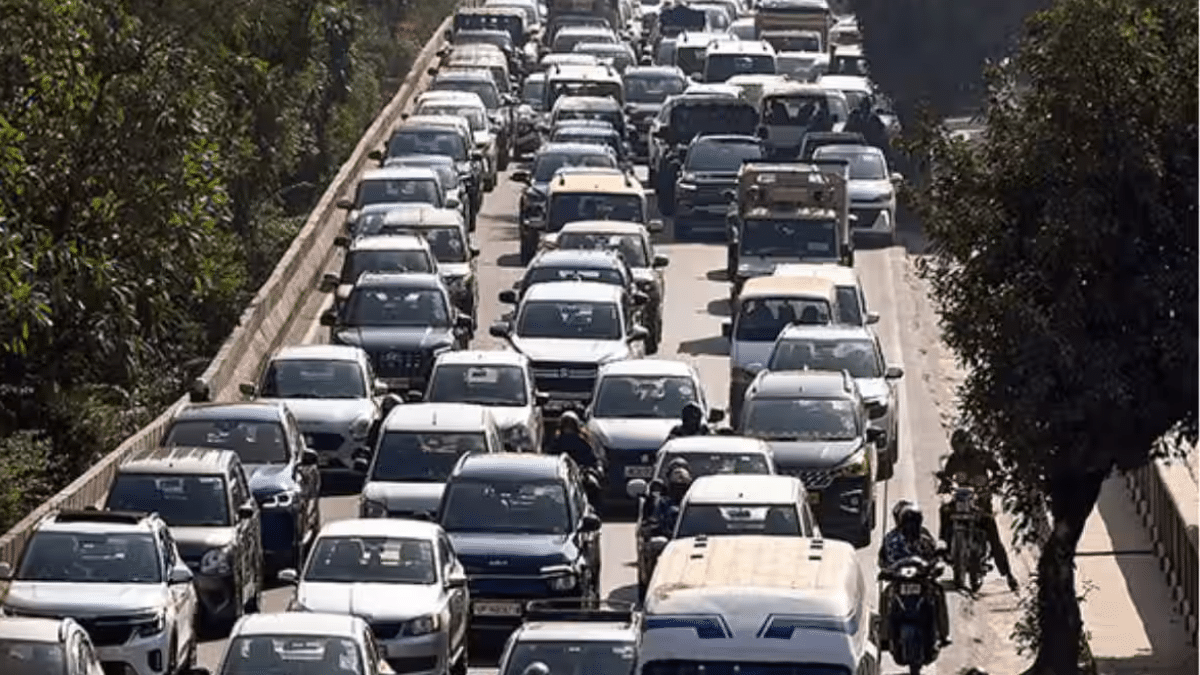 Heavy traffic on Indian roads with mix of new cars and two-wheelers showing rising vehicle population