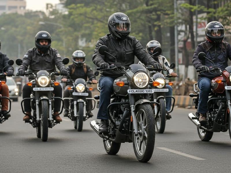 A rider on a 125cc motorcycle riding on an Indian highway