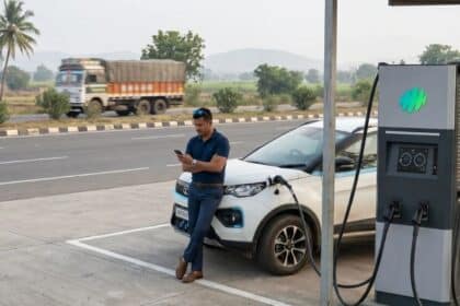 Electric vehicle charging at a public DC fast charging station on an Indian highway
