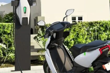 An electric motorcycle connected to a home charging setup in India