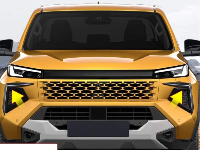 Close-up of the 2026 Toyota Hilux's redesigned LED headlamps and honeycomb grille with black connecting panel