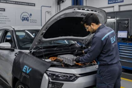 Technician servicing an electric vehicle at a service center in India