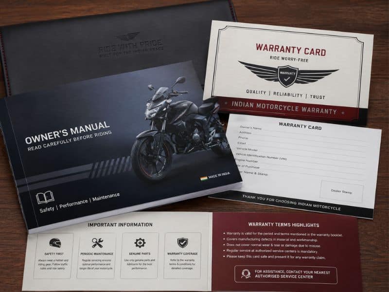 Motorcycle owner's manual and warranty card placed beside a bike key in India