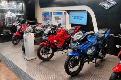 Rows of motorcycles and scooters parked at an Indian dealership showroom, representing two-wheeler dealer inventory for the July 2026 wholesale vs retail analysis.
