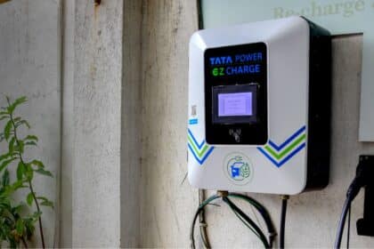 Tata Sierra EV plugged into a wall-mounted home charger in a residential parking spot