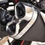 Close-up of a motorcycle exhaust muffler on an Indian street