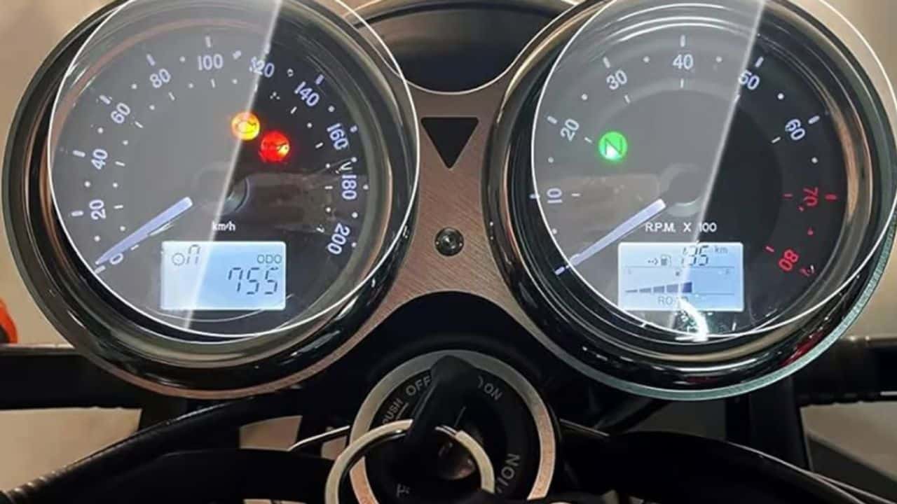 Motorcycle instrument cluster showing fuel gauge and speedometer representing the mileage versus performance trade-off