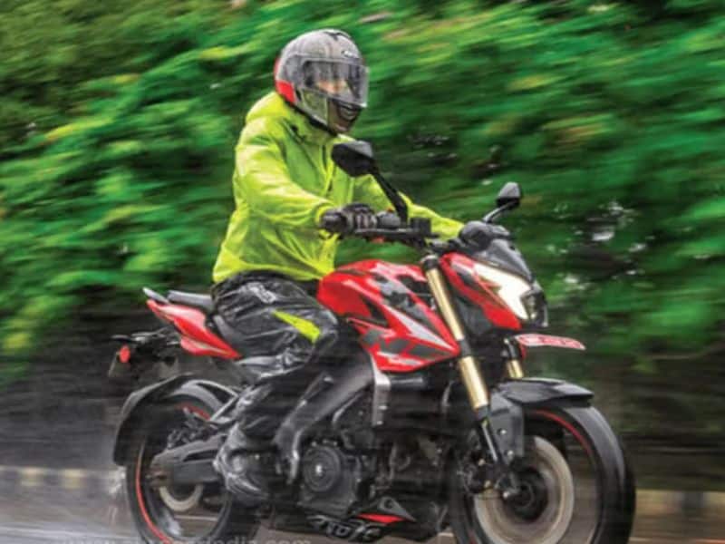 A motorcyclist wearing waterproof riding gear during monsoon rain in India