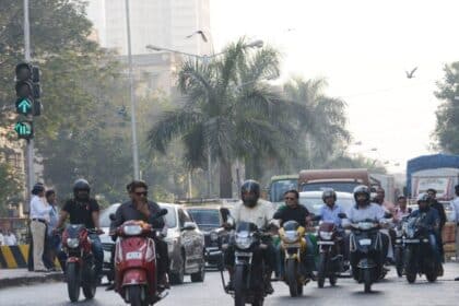 A motorcycle and a scooter parked side by side representing the two-wheeler choice comparison